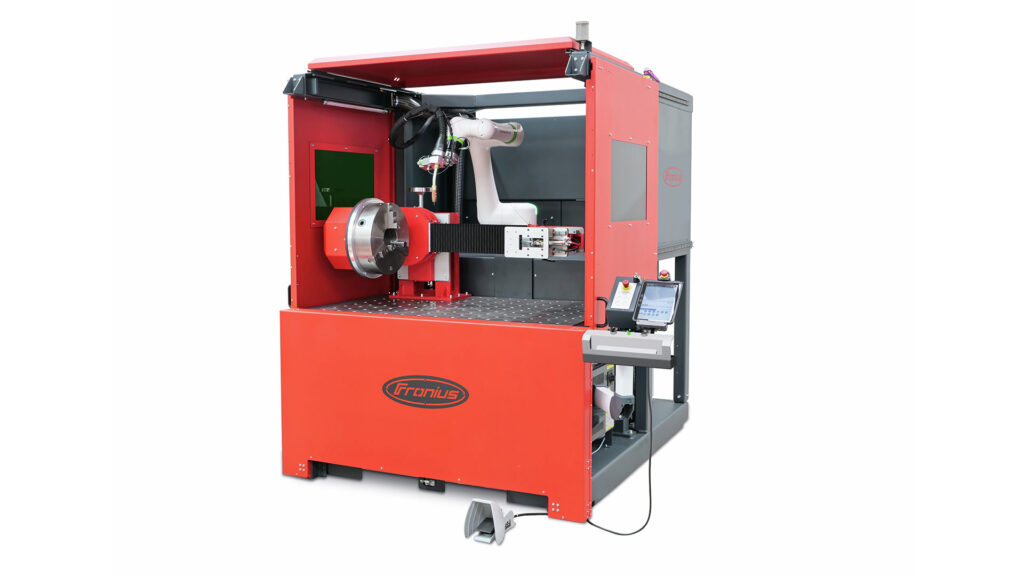 Fully enclosed CWC-S cobot welding cell with motorized turntable and tailstock, auto-closing screen, and welding fume extraction. Working area: 1,500 x 1,000 x 600 mm.